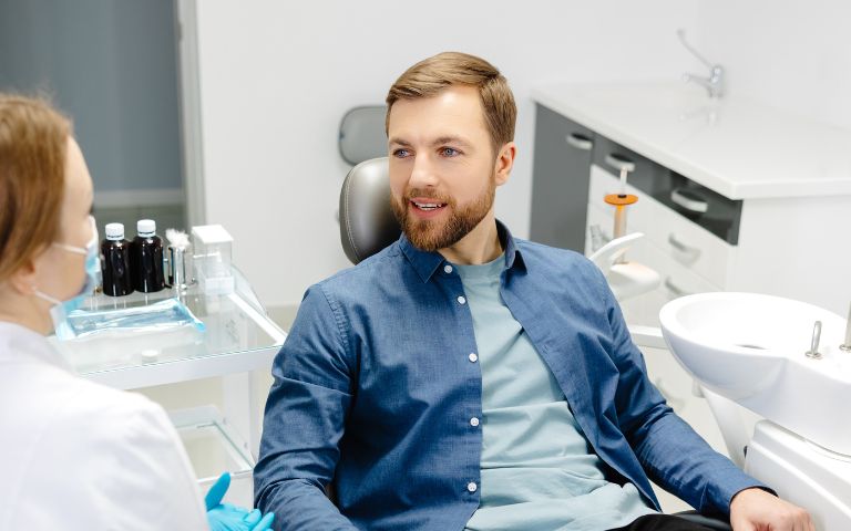Male patient discussing ridge augmentation candidacy with a dentist at Cleopatra Dental