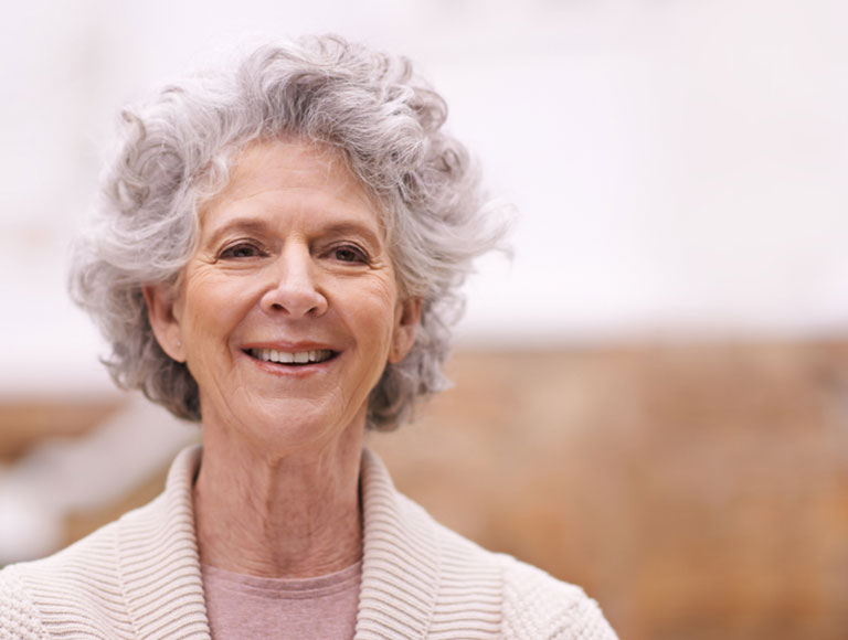 senior woman smiling with dentures in huntington beach