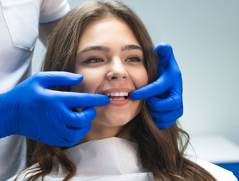 Cosmetic dentist showing patient’s smile makeover results in Huntington Beach