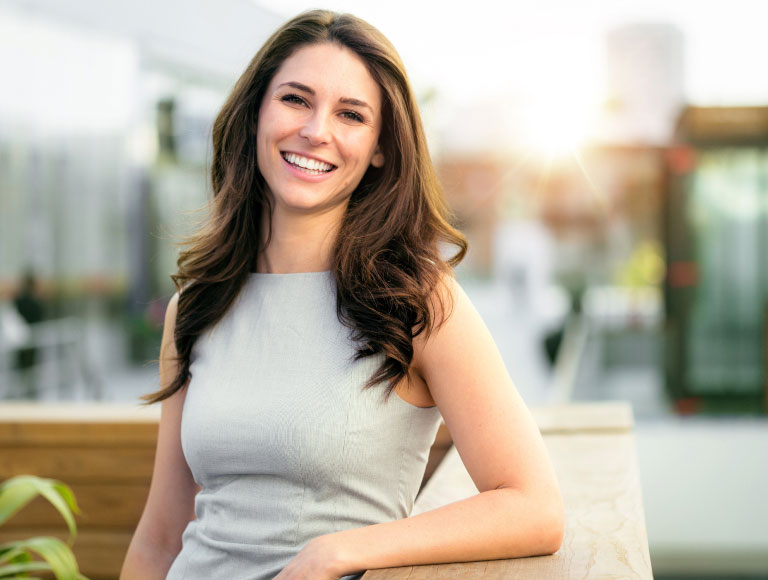 Happy woman smiling confidently after receiving a dental filling