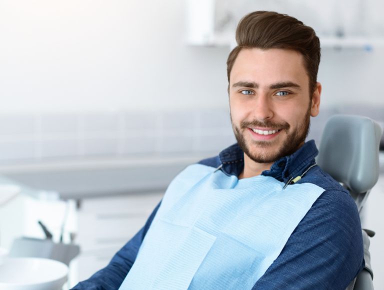 man after getting dental crowns at cleopatra dental in huntington beach