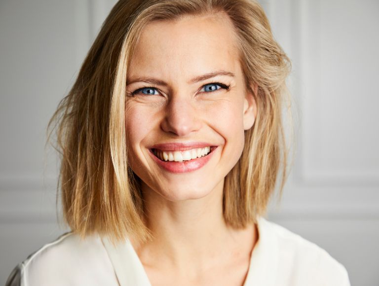 happy woman smiling with dental implants in huntington beach