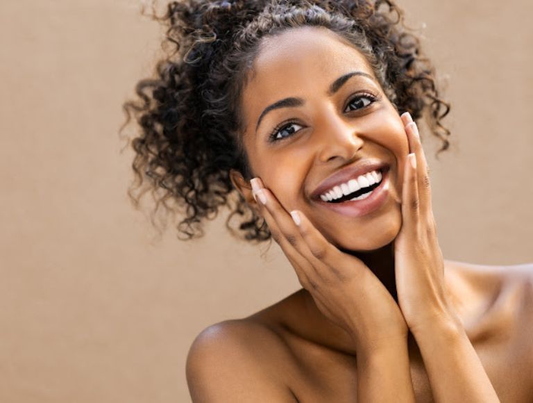 Smiling woman after cosmetic dentistry treatment in Huntington Beach
