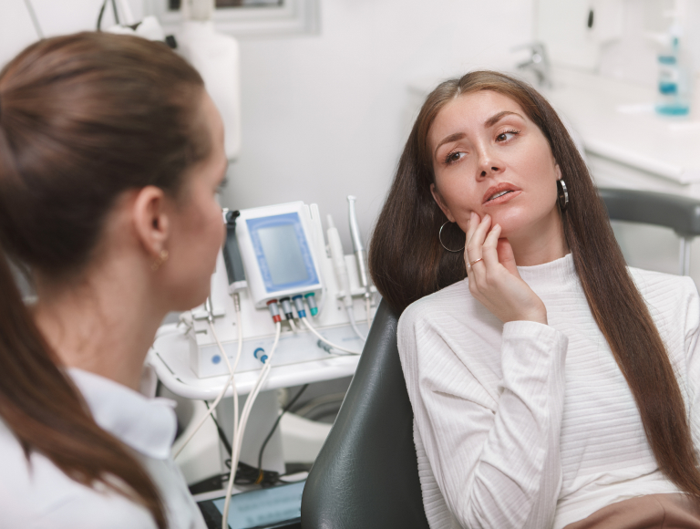 patient expressing tooth pain during consultation in huntington beach