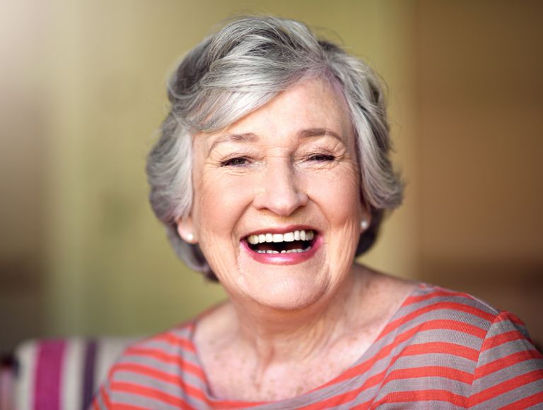 Smiling woman after general dental treatment
