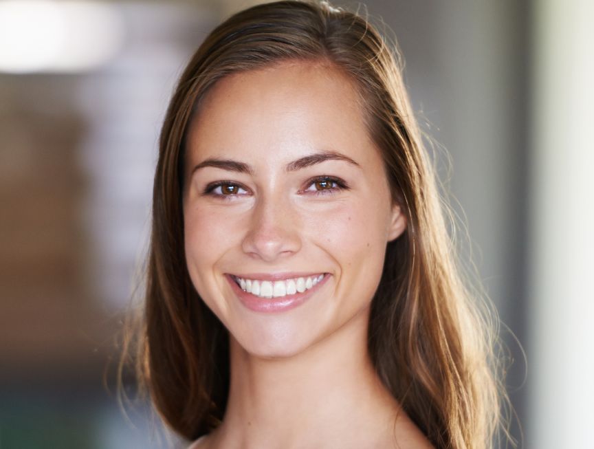 Female patient experiencing relief after TMJ treatment in Huntington Beach