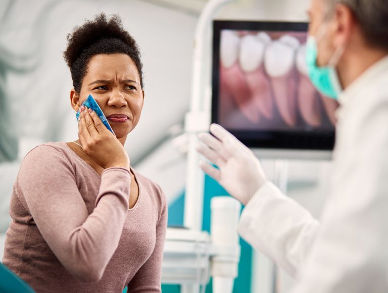 Female patient in pain before wisdom teeth removal in Huntington Beach