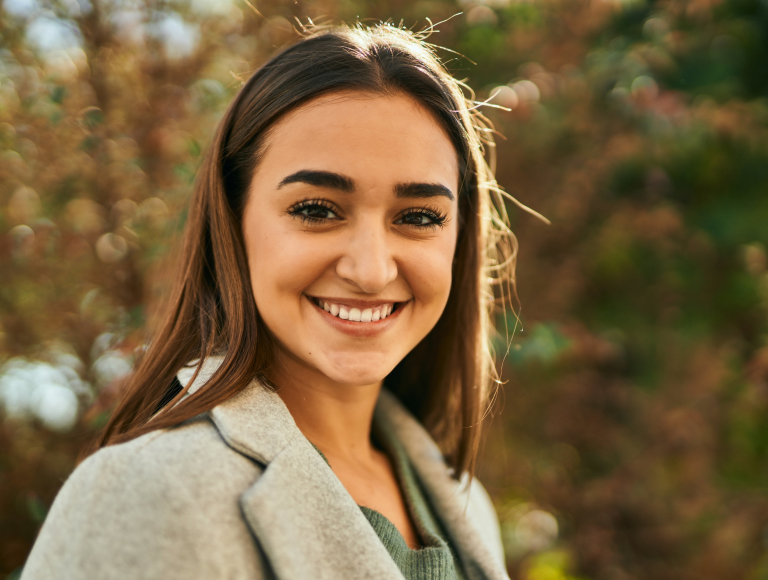 Smiling female patient after wisdom teeth removal in Huntington Beach